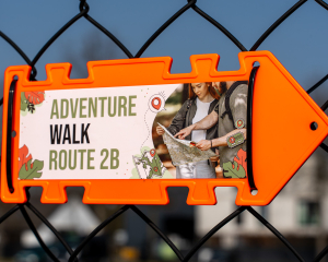 Neon orange Arrow Sign attached with black Cable Ties