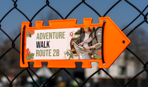 Neon orange Arrow Sign attached with black Cable Ties